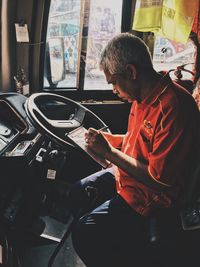 Side view of man using smart phone