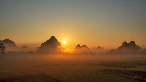 Scenic view of mountains against sky during sunset