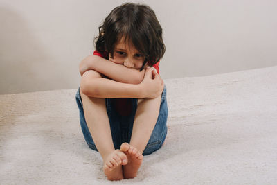 Cute girl sitting on floor