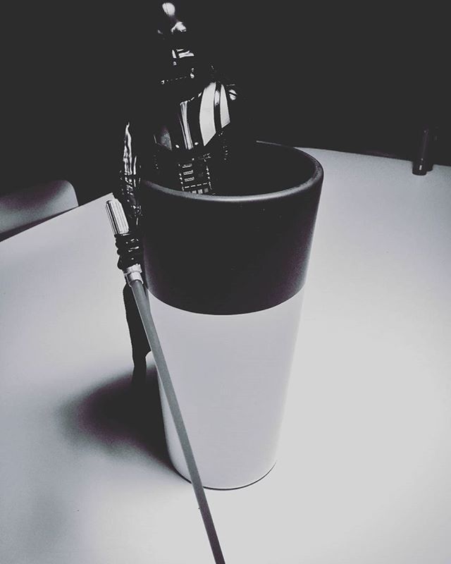 low angle view, close-up, still life, lighting equipment, indoors, no people, focus on foreground, metal, hanging, table, day, shadow, architecture, built structure, sunlight, street light, electricity, selective focus, illuminated