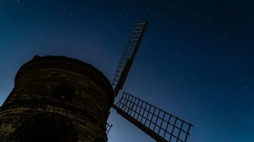 Low angle view of windmill against sky at night