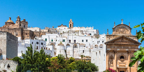 Low angle view of buildings against blue sky