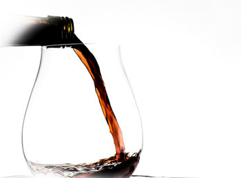 Close-up of beer bottle against white background