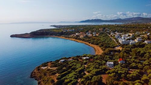 High angle view of townscape by sea against sky