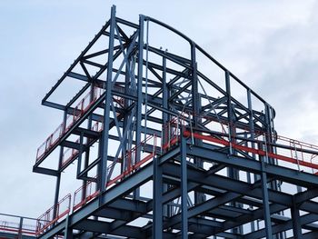 Low angle view of crane against sky