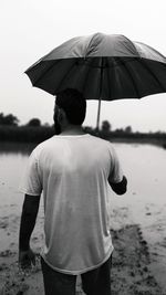 Rear view of man standing on beach