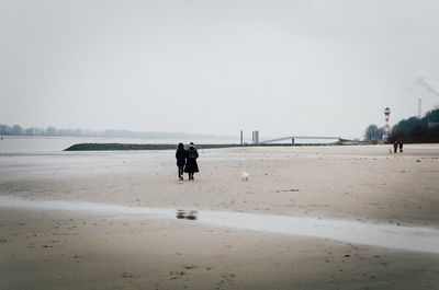 Man standing on beach against sky