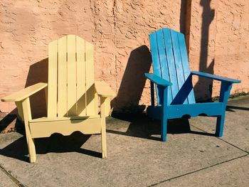 High angle view of chairs on street against wall