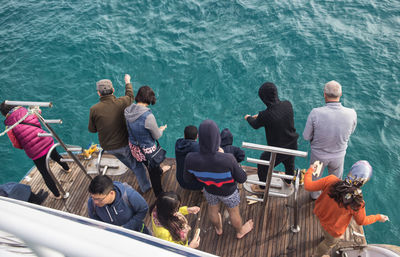 High angle view of people sitting on boat in sea