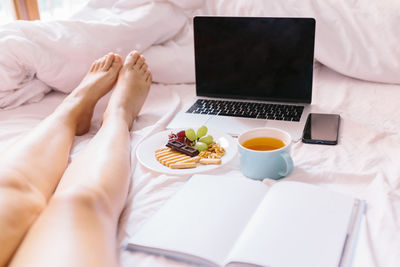 High angle view of man using laptop on bed