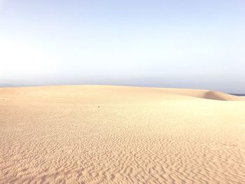 Scenic view of desert against clear sky