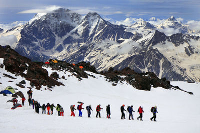 People on snowcapped mountain