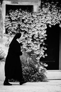 Woman standing on tree trunk