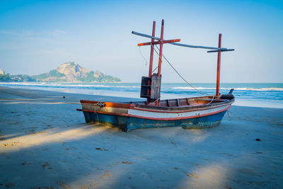 An old fishing boat on the beach with sea background. sea coast line. copy space for text.