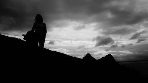 Silhouette of mountain against cloudy sky