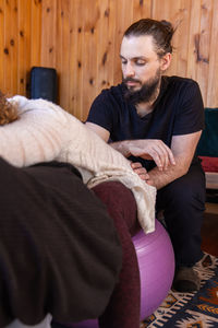 Portrait of senior man sitting on sofa at home