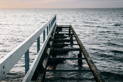 Staircase by sea against sky