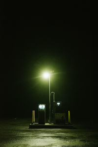 Lonely street lamp and fuel pump in iceland at night.