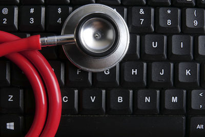 Directly above shot of stethoscope and computer keyboard