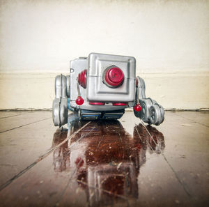 Close-up of toy car on table against wall