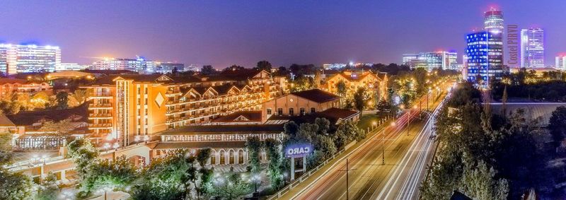 High angle view of city lit up at night