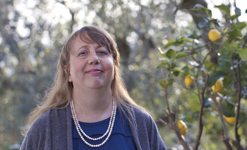 Portrait of smiling woman standing outdoors