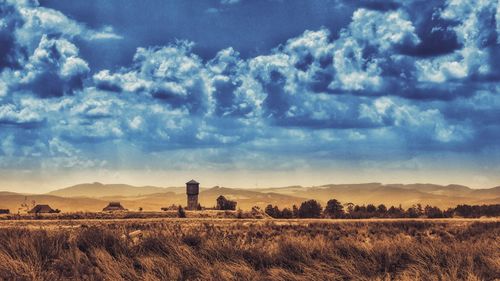 Scenic view of farm against sky