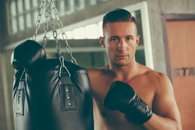 Shirtless boxer practicing boxing