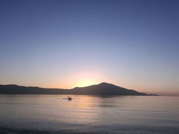 Scenic view of sea against clear sky during sunset