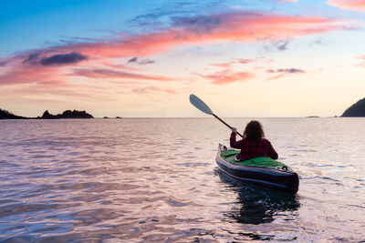 Boat in sea against sky during sunset