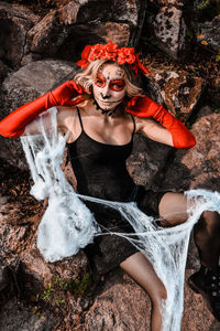 Closeup portrait of calavera catrina. young woman with sugar skull makeup and white spiderweb. dia 