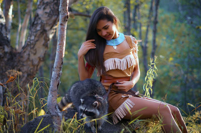 Portrait of smiling young woman sitting outdoors