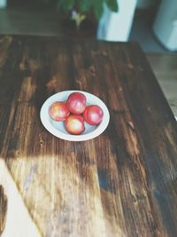 Close-up of red chili peppers on wooden surface