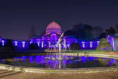 Illuminated temple against sky at night