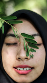 Close-up of young woman with eyes closed