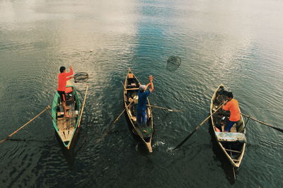 High angle view of men boating on lake