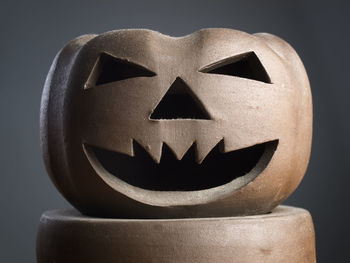 Close-up of pumpkin face against black background