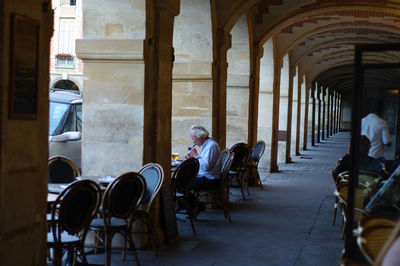 People sitting in corridor of building