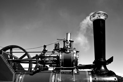 Low angle view of machinery against sky