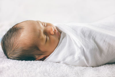 Cute baby sleeping on bed