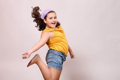 Portrait of smiling girl against white background