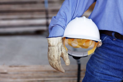 Close up of a male construction foreman holding a hard hat