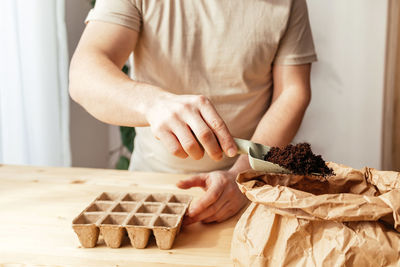 Midsection of man preparing food