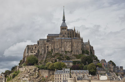 Low angle view of historical building against cloudy sky