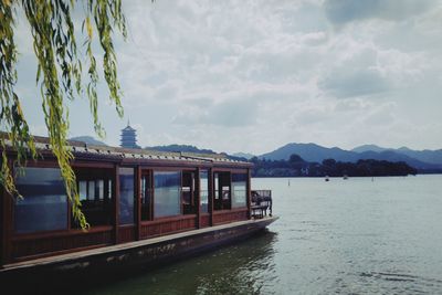 Built structure by river against sky