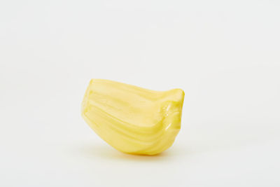 Close-up of yellow cake against white background