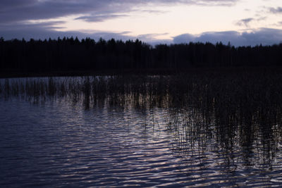 Scenic view of lake against sky at sunset
