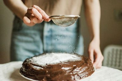 Midsection of woman holding ice cream