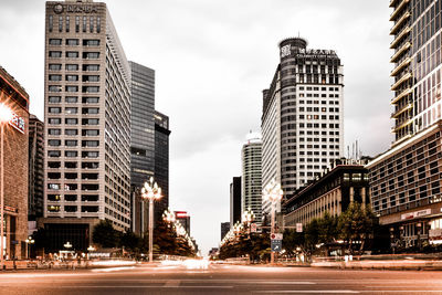 City street and buildings against sky