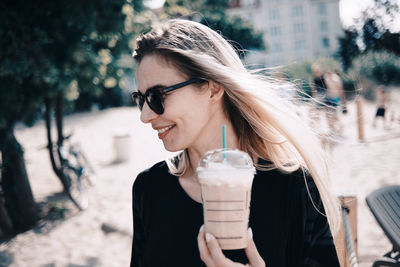 Young woman wearing sunglasses standing outdoors